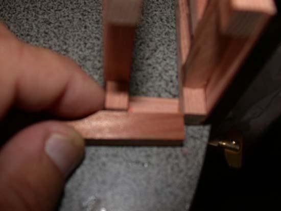 Take a piece of 4 x 8 material and, working on the glued end, butt one end against one side and mark where it meets the other side. Cut it to length and test fit it between the sides.