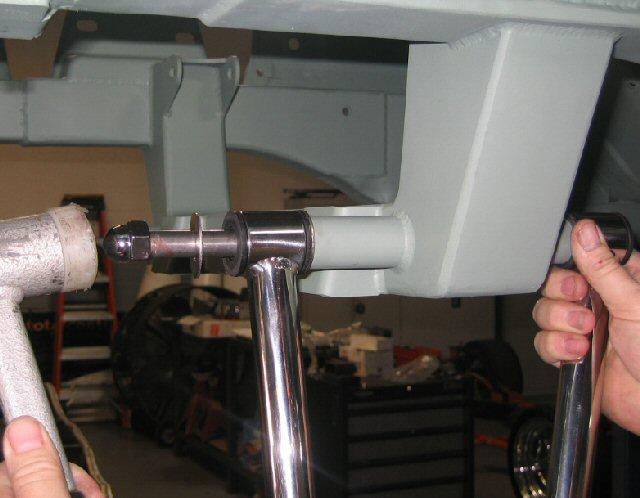 Install the a-arm onto the cross member and install the nylock nut using anti-seize on the threads and tighten.