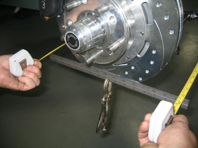 Clamp a straight edge to each rotor as shown then using a tape measure front and