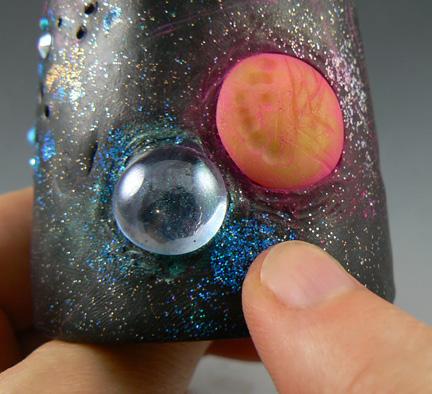 7 Add more powders and glitters around the glass planets too.