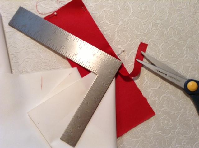 It s important that white fabric lay right along crease of red border and that long border edges line up with each other on opposite sides. Move and re-pin as needed to achieve this.