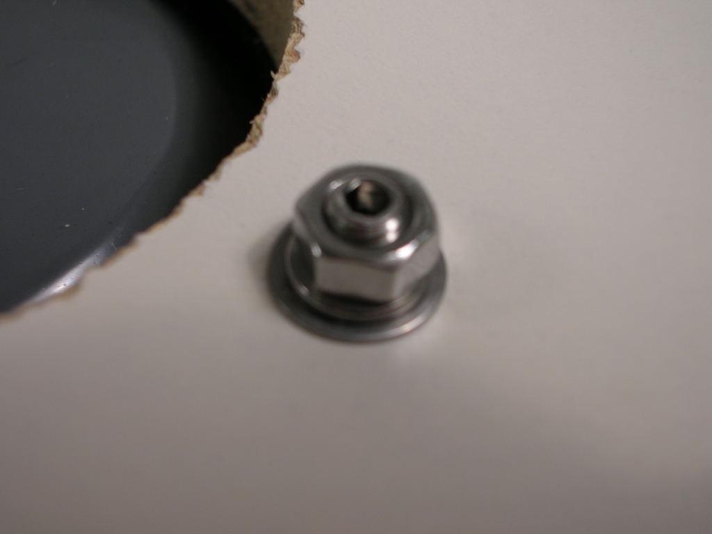 10) Secure the Head in place with a flat washer, M5 Lock Washer and M5 Hex Nut on each of the Set-screws, from the back side o\f the mounting surface. Do not over-tighten the nuts.