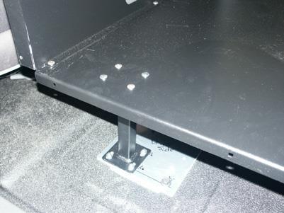 Slide K9 main housing to line up with forward floor mounting plate holes.