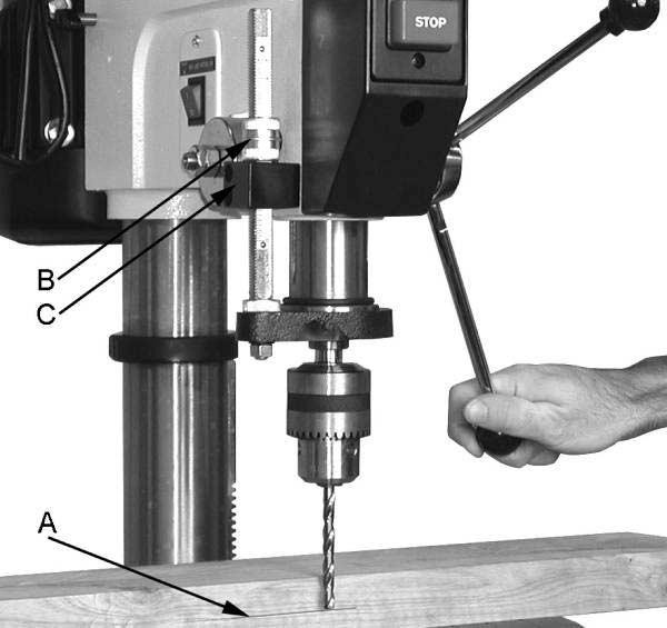 Insert the drift key (B, Fig. 9) into the aligned slots and tap lightly. The chuck and arbor assembly should fall from the spindle.