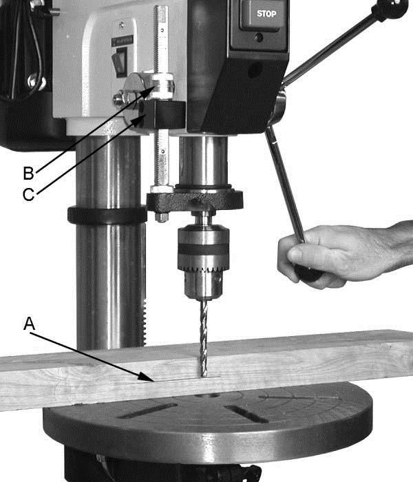Insert the drift key (B) into the aligned slots and tap lightly. The chuck and arbor assembly should fall from the spindle.