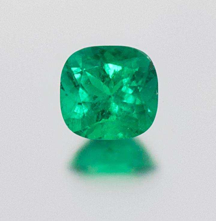 Lot 235 A 6.56 Carat Cushion Cut Colombian Emerald, measuring approximately 12.90 x 12.50 x 8.01 mm.