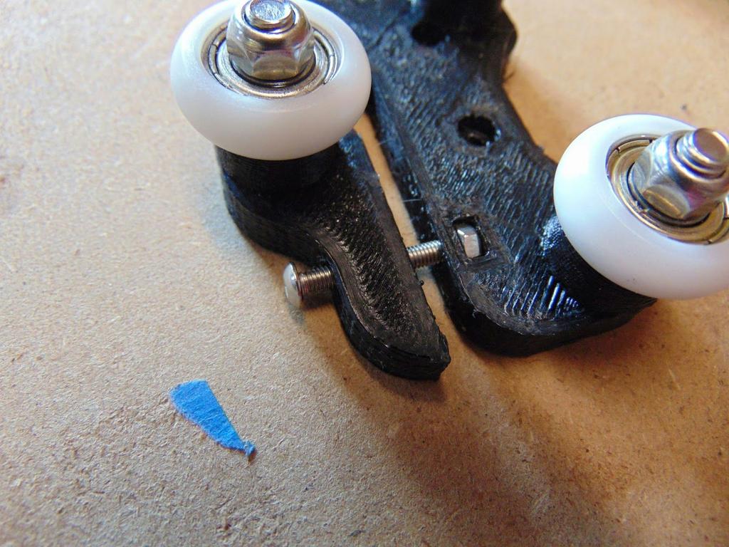 Insert the M3x20mm bolt through the side hole on the slider bracket and place the M3 Nut in the slotted opening in line with bolt and thread them