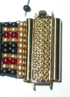 centered on the clasp find two skinny black size 8 seed beads and tuck one