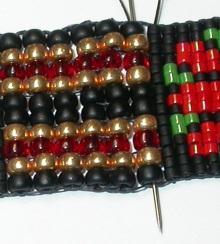 Skip the last Delica strung and pass back up all beads to exit the first gold seed.