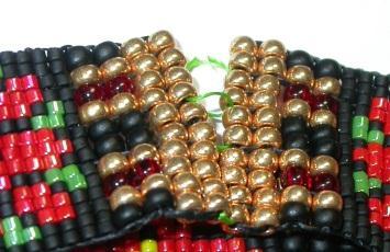Open the beadwork by carefully snipping the OTHER color thread between the