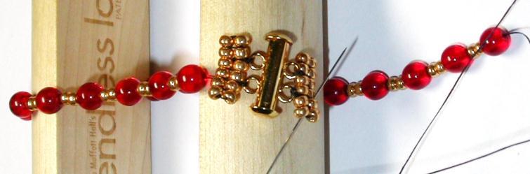 String one 6mm (round or fire polish) 2 seeds, repeat to fit around the loom. 15.