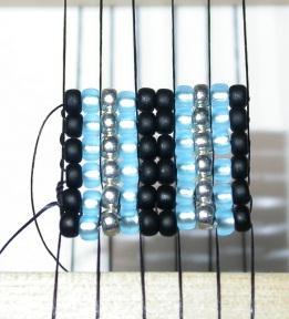 Pass needle back through the row of beads just