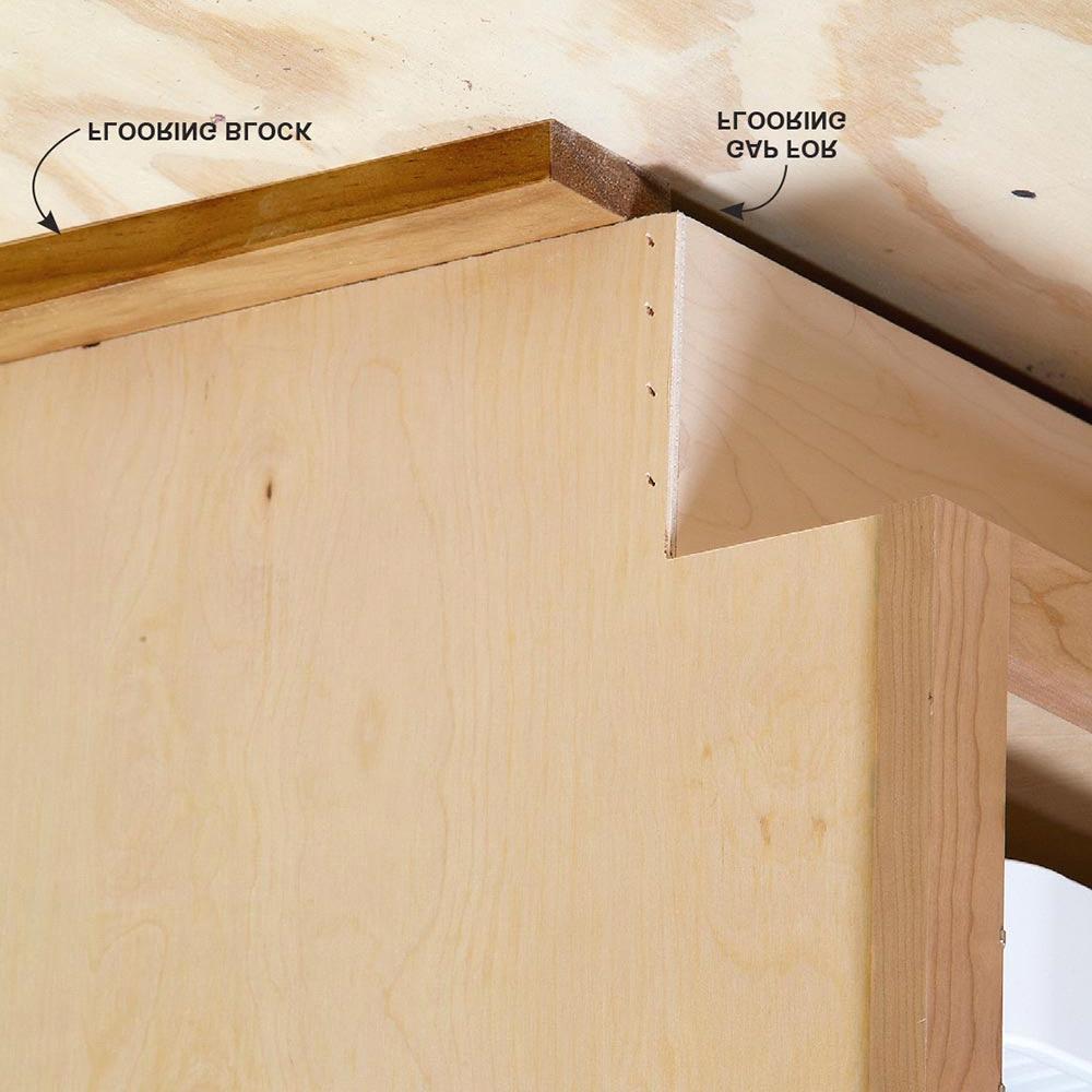 Anchor the island cabinets to the 2x2s with screws. If needed, place flooring blocks under the 2x2s.