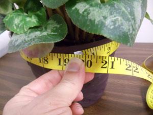 Using a tape measure, measure the circumference of the pot at the top edge and then add 1 1/2 inches for allowances (ours measures 19 1/2 inches - 19 1/2 inches plus 1 1/2 inches equals 21 inches).