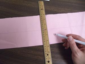 To prepare the fabric for the top of the outer shell, cut a piece of the canvas using your width measurement (ours is 21 inches) by 5 1/2 inches high.