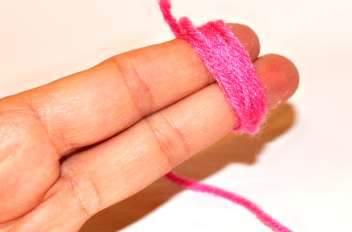 WREATH 3: 3 Take pink yarn and wrap it around your first two left fingers