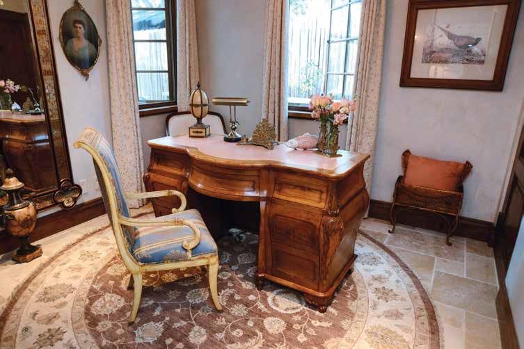 An elegant custom-built walnut desk featuring a 24k gold embossed leather