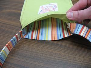 With the inner bag turned wrong side out, pin the ends of the strap to the side seams of the bag