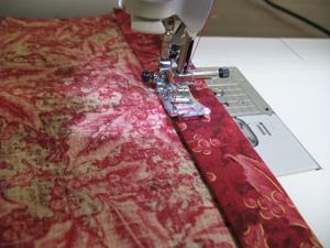 Sew a 1/8 inch seam along the bottom edge of the folds on both pieces of fabric.