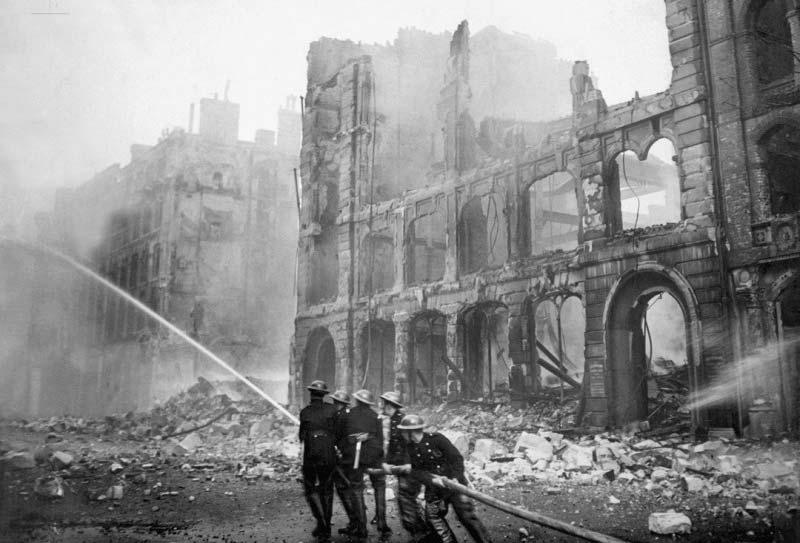 Picture 13 Firemen extinguishing fires in bombed out buildings in London.
