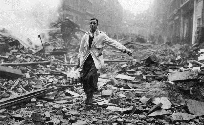 Picture 2 A milkman delivering milk in a London street devastated during a German bombing raid.