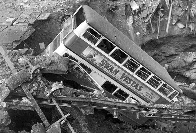 Picture 4 A double decker bus, advertising Swan Vesta matches, in a bomb crater in Balham, London.
