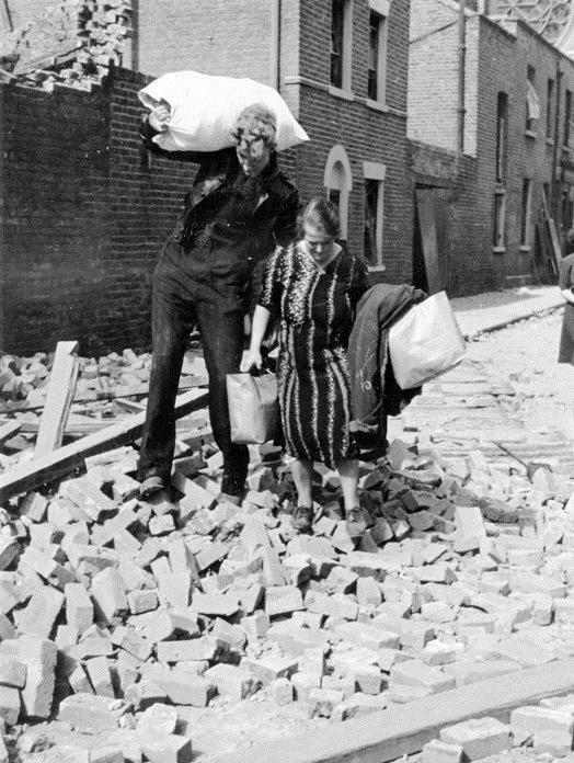 Picture 8 Two people carrying their belongings after bomb damage to their homes in the East End of London.