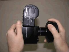Hold the DC with one hand and the lens with the other hand then rotate the lens gently to tightly fix the two together.