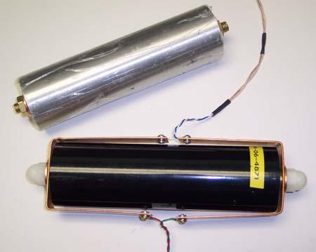 Figure 2 is a photograph of the battery in the fixture and the battery surrogate. The current carrying wires are on one side of the battery and the sense wires are on the other.