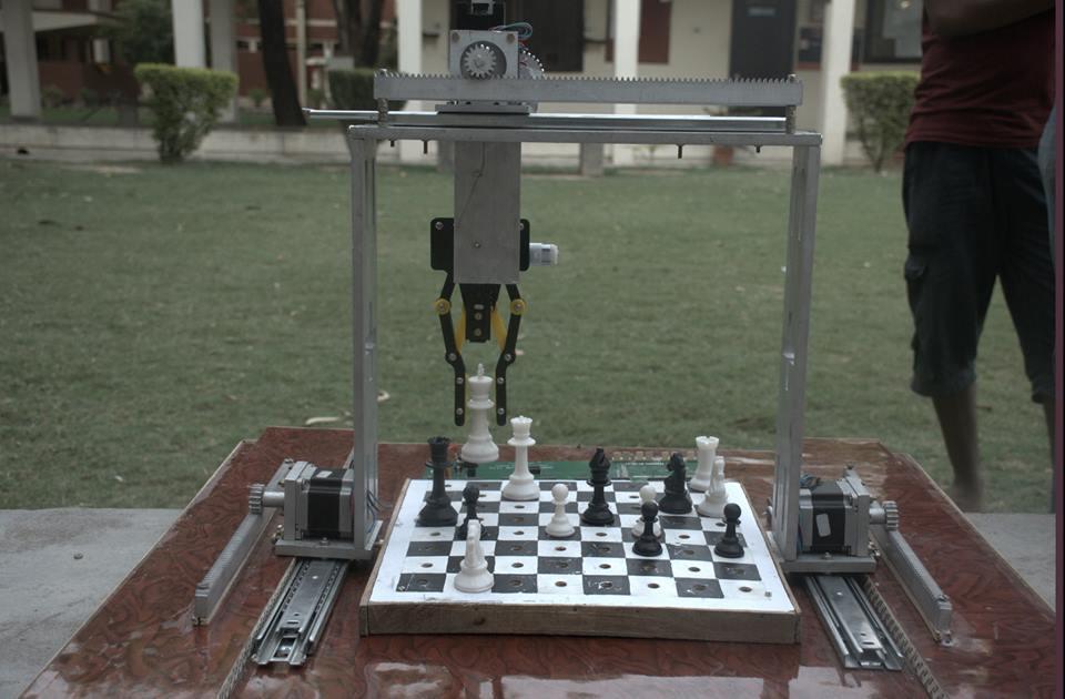 Design A 12 X 12 wooden chessboard lies on a wooden platform, flanked on each side by a vertical slider, rack and pinion.