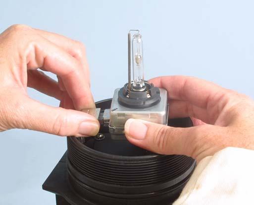 While holding the lamp assembly in one hand, carefully unplug the lamp power connector (Fig. 13). Set the defective lamp aside.