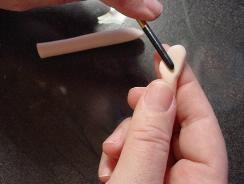Using a paintbrush handle or other round tool, indent the area