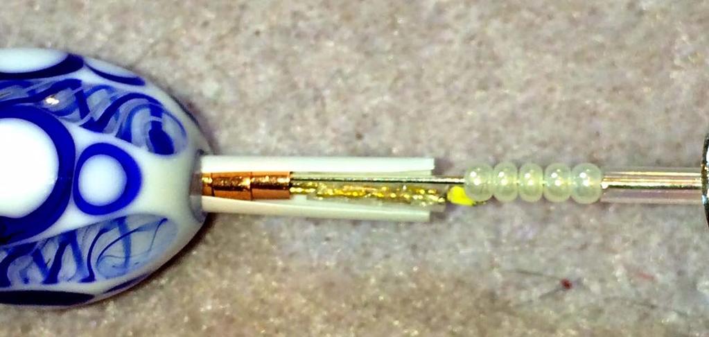the LED strand, all running parallel to each other. Any beads you need to put on this length (e.g. under the cone to hold the headpin in place) must fit over all three wires at once.