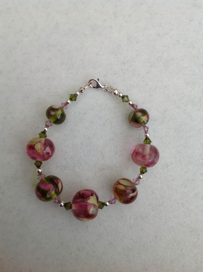 The glass beads have been matched with Swarovski crystals in olivine and light amethyst that add