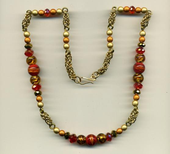 Orange and amber beads set on brass wire with