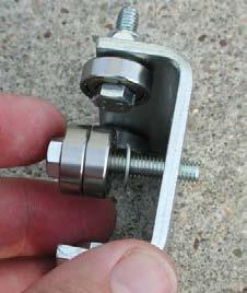 3. Using the two (2) remaining long bolts, reattach the center bearings to the