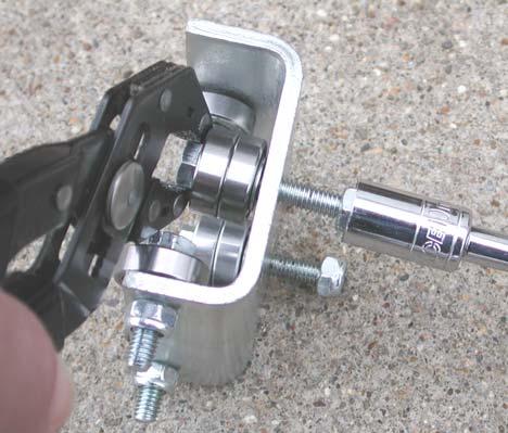 At this time, use fingers or a socket to twist nuts onto the bolts so the bearings