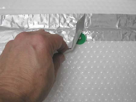 Use additional plastic caps to secure the remaining plastic cap nails to the Tek foil seam and