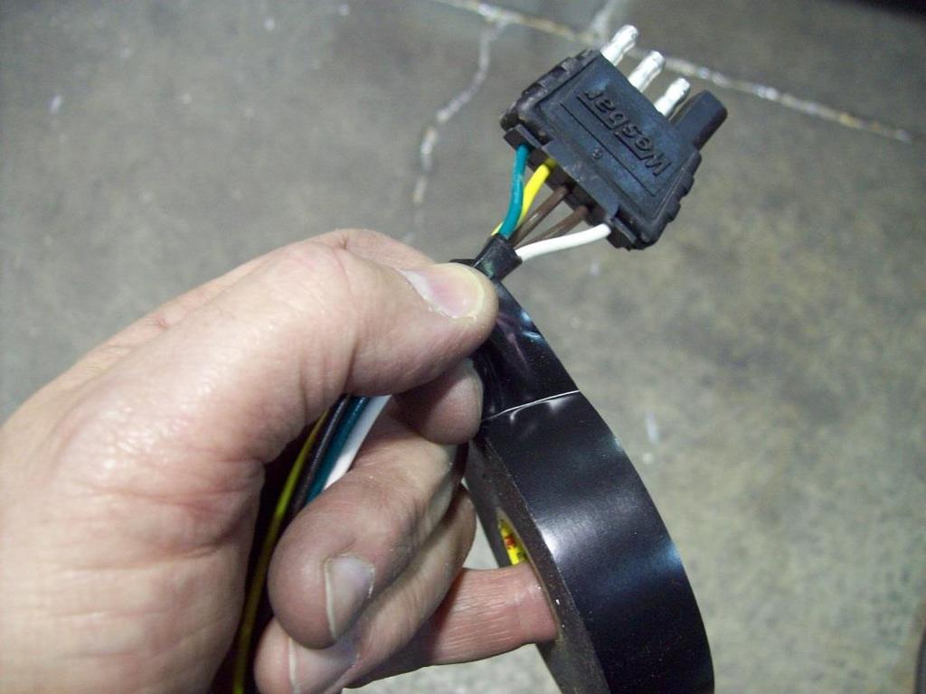 With electrical tape start at the four prong connector, keeping the