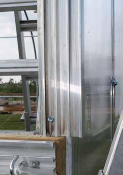 Photos show a building with an optional end wall with polycarbonate cladding. Additional purchase required.