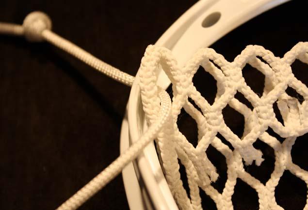 After inserting the topstring through plastic hole, push the string up through
