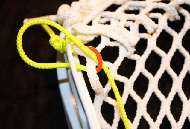 Once through the 3rd mesh diamond and 2nd sidewall hole, push the string over the sidewall rail.