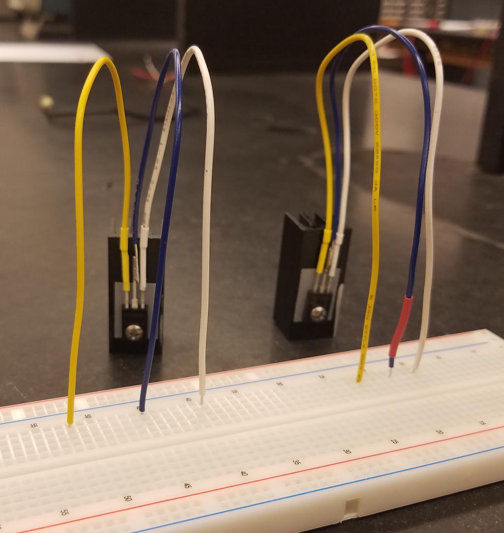 Figure 2: The BD140 (left) and BD139 (right) power transistors as prepared for this lab. Both transistors are mounted on an aluminum heat sink with an electrically insulating thermally conductive pad.