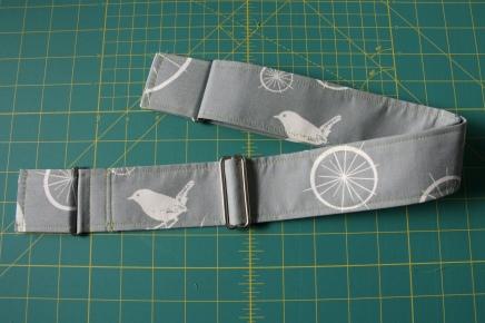 Flatten out the strap and sew the second loop/tab to the free end, folding under the raw