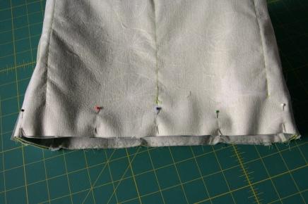 Baste the strap tabs to the sides of the bag, right sides facing and centered over the