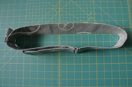 Thread the strap through the metal slide, fold the end over and topstitch in place.