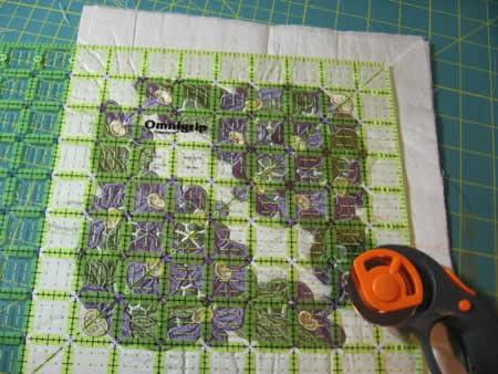 When both embroideries are complete, use the rotary cutter and ruler to