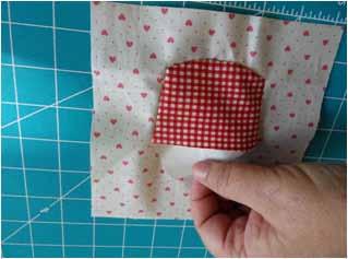 Overlay the 6 ½" x 6 ½" template of the block outline over one of the 6 ½" x 6 ½" squares of the Pink Hearts on Cream fabric 567-P2, and use the diagram to position a cupcake base piece (Illustration