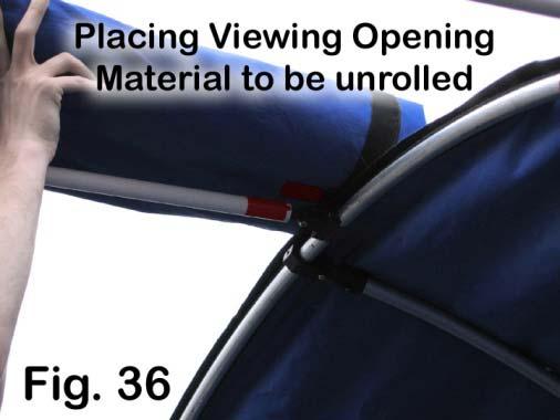 The final step is to put the View Opening section of material in place. It is stored, rolled up onto two dowels. Find the red mark which indicates the center (Fig.