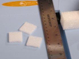 3 To create the scrapbook page, begin by making some foam ice cubes. Cut a block of white foam, which has a sparkly texture, into a 1" square column.